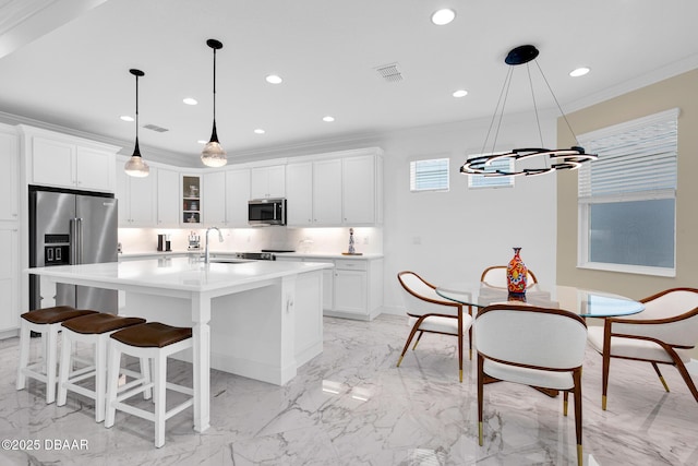 464 Tropics Ave, Daytona Beach, FL 32124 - kitchen with stainless steel appliances, a chandelier, light marble finish floors, crown molding, and recessed lighting