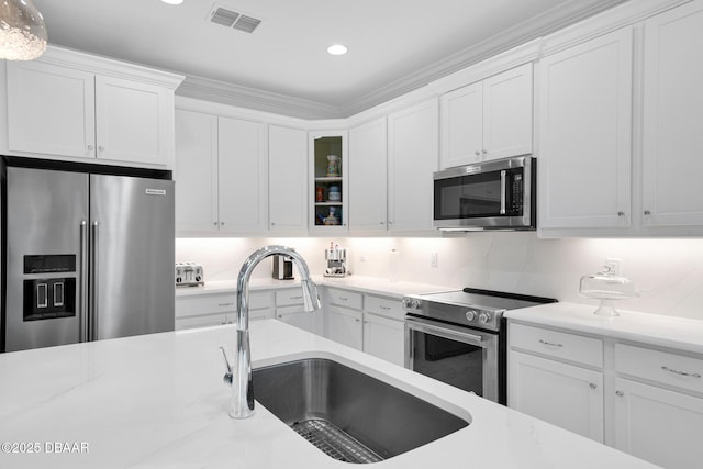464 Tropics Ave, Daytona Beach, FL 32124 - kitchen with stainless steel appliances, a sink, white cabinetry, light countertops, and recessed lighting