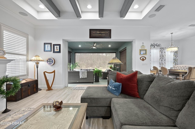 living room with hardwood / wood-style floors, a wealth of natural light, crown molding, and ceiling fan