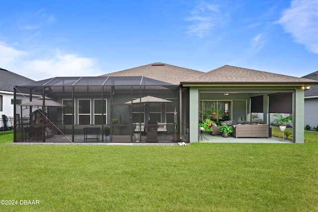 back of property with a patio area, a lanai, an outdoor hangout area, and a yard