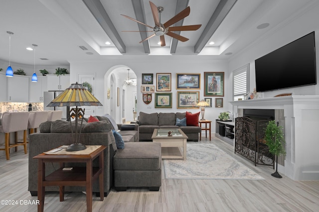 living room with beamed ceiling, ceiling fan, light hardwood / wood-style floors, and ornamental molding