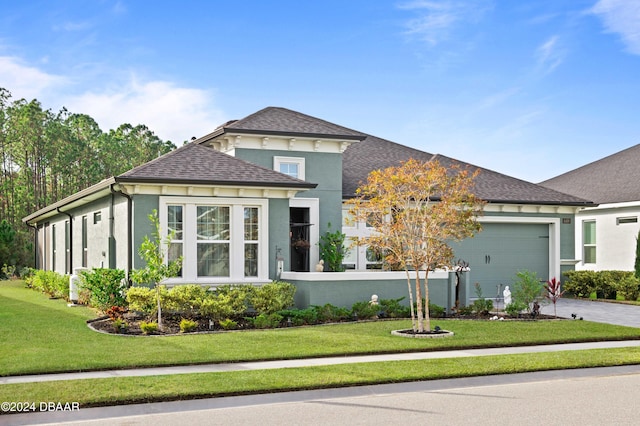 view of front of home with a garage and a front lawn