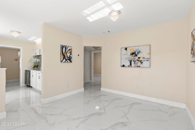 empty room featuring visible vents, marble finish floor, and baseboards