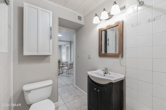 823 N Arlington Ave, Deland, FL 32724 - bathroom with tile patterned floors, vanity, toilet, and ornamental molding