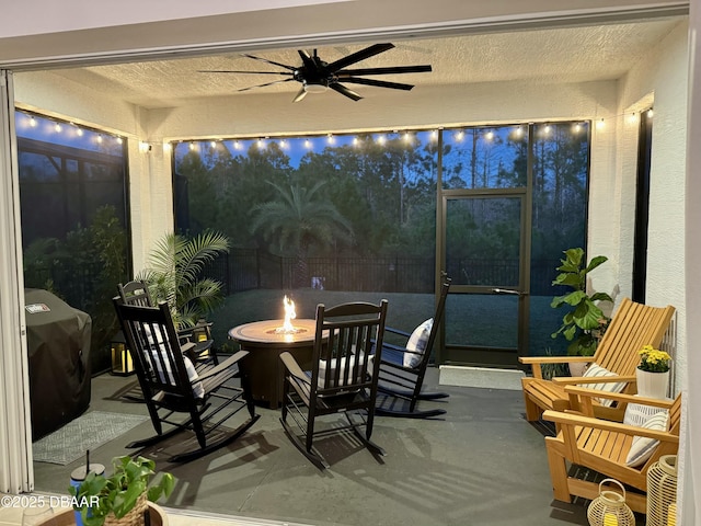 view of patio with a grill, a fire pit, ceiling fan, and fence