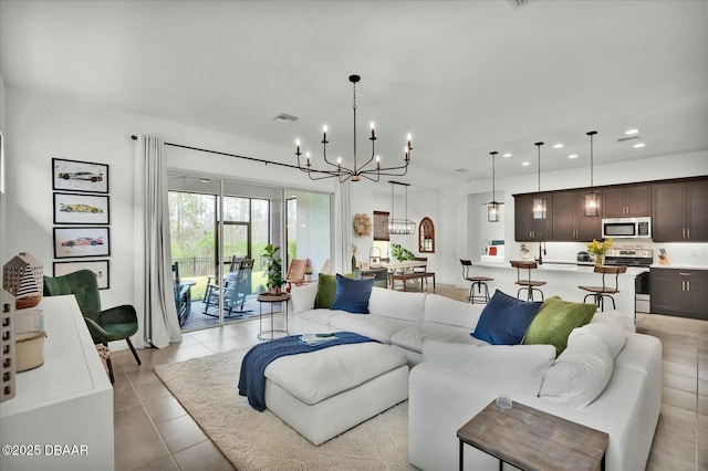 living area featuring an inviting chandelier, light tile patterned flooring, recessed lighting, and visible vents