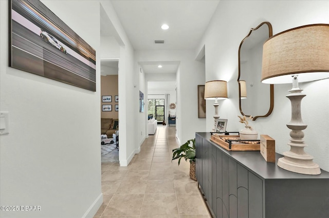 corridor with recessed lighting, light tile patterned floors, baseboards, and visible vents