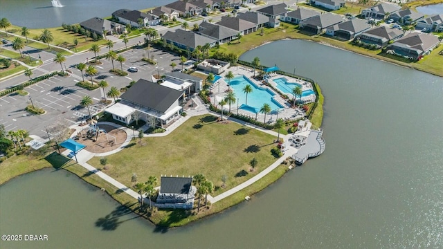 drone / aerial view featuring a residential view and a water view