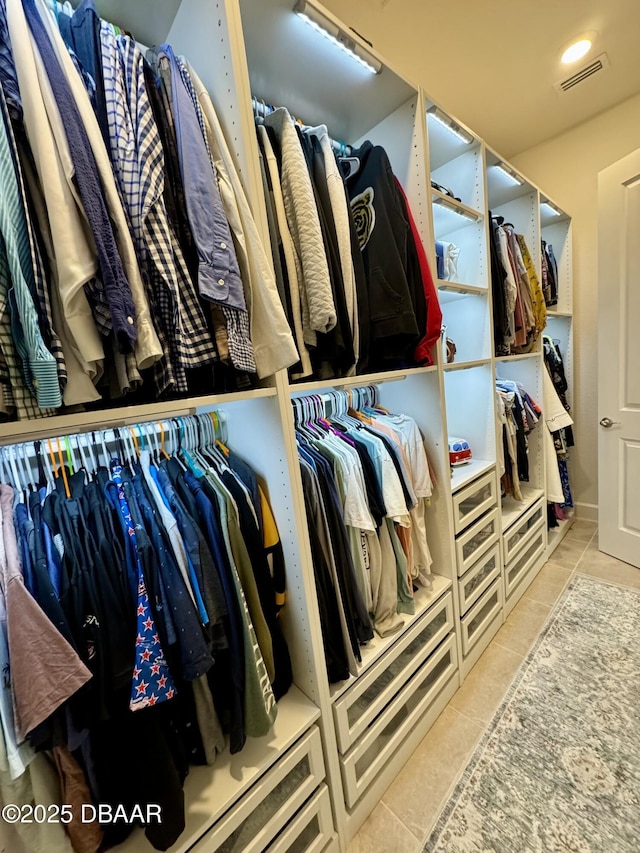 spacious closet featuring light tile patterned flooring and visible vents