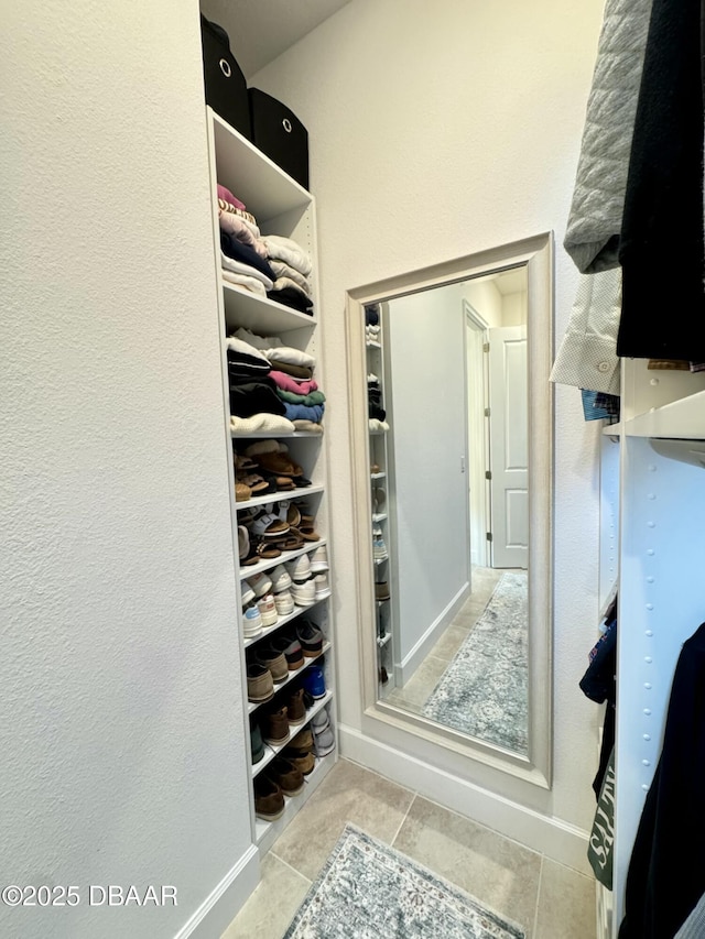 spacious closet featuring tile patterned flooring