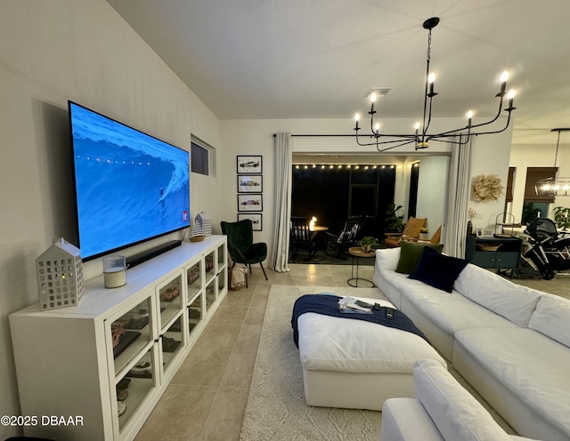 living room featuring a chandelier and tile patterned flooring