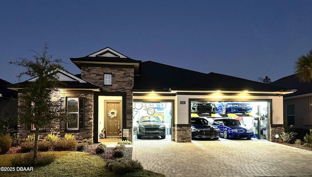 view of front of property featuring stone siding and decorative driveway