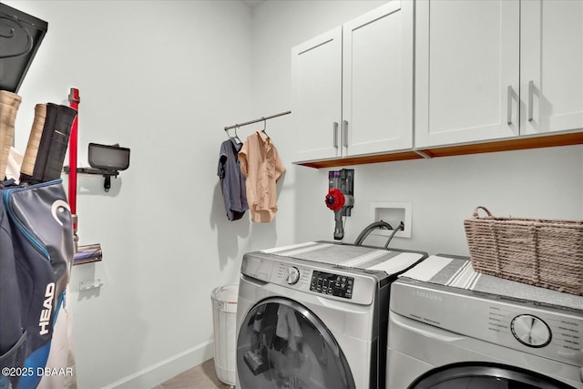 laundry room featuring washer and dryer, cabinet space, and baseboards