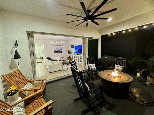 view of patio / terrace featuring ceiling fan and an outdoor fire pit