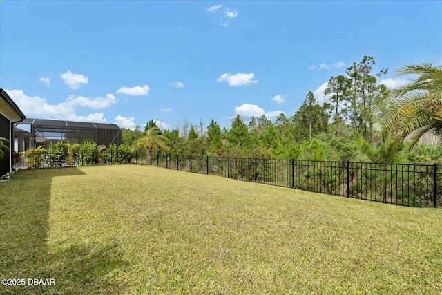 view of yard featuring a lanai and fence