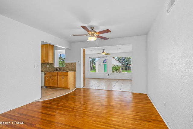 1104 Jacaranda Ave, Daytona Beach, FL 32118 - unfurnished living room with a ceiling fan, light wood-type flooring, and a textured wall