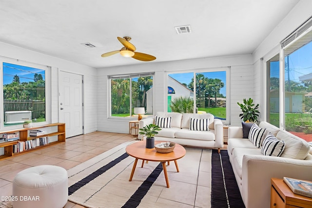 1104 Jacaranda Ave, Daytona Beach, FL 32118 - living area with healthy amount of natural light, a ceiling fan, and light tile patterned floors