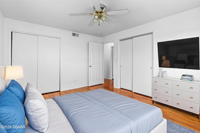 1104 Jacaranda Ave, Daytona Beach, FL 32118 - bedroom with two closets, light wood finished floors, and ceiling fan