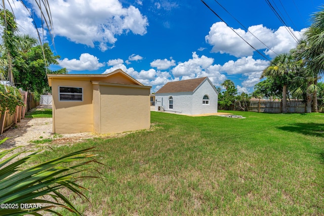 1104 Jacaranda Ave, Daytona Beach, FL 32118 - fenced backyard featuring an outbuilding