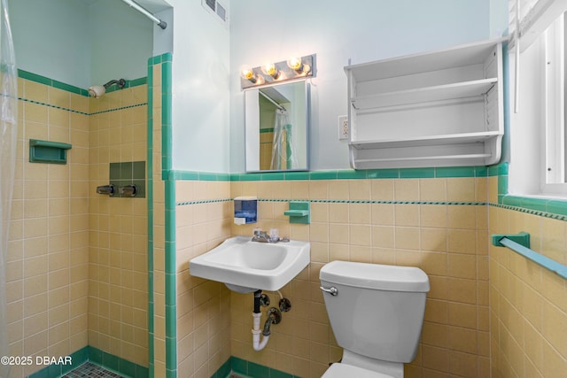 1104 Jacaranda Ave, Daytona Beach, FL 32118 - bathroom with a shower stall, tile walls, and wainscoting