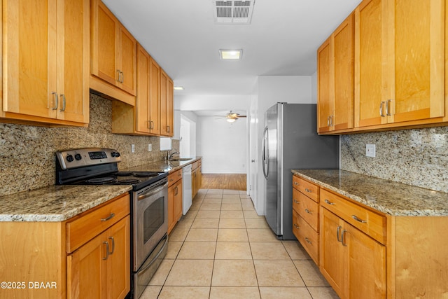 1104 Jacaranda Ave, Daytona Beach, FL 32118 - kitchen featuring stainless steel appliances, light tile patterned floors, a ceiling fan, and tasteful backsplash