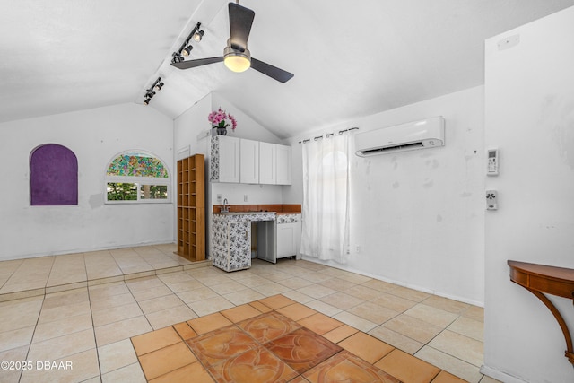 1104 Jacaranda Ave, Daytona Beach, FL 32118 - kitchen featuring an AC wall unit, ceiling fan, white cabinets, lofted ceiling, and light tile patterned floors