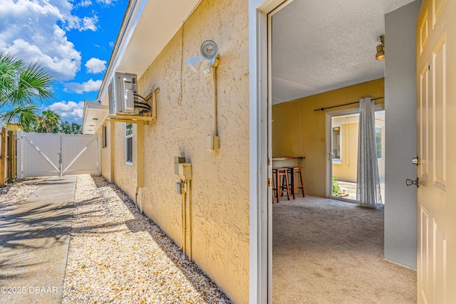 1104 Jacaranda Ave, Daytona Beach, FL 32118 - view of side of home with a gate and stucco siding