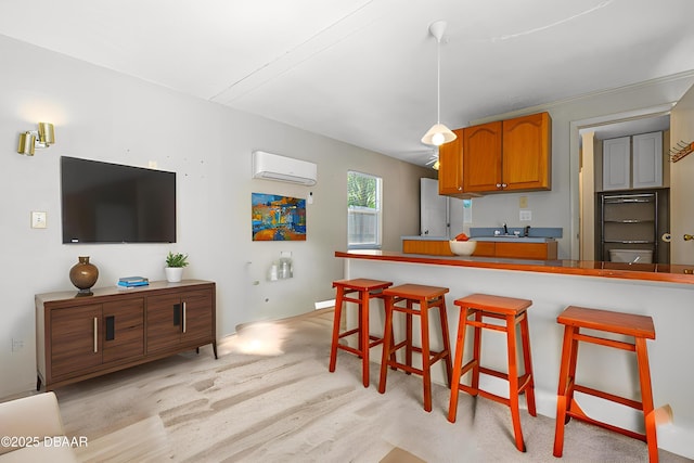 1104 Jacaranda Ave, Daytona Beach, FL 32118 - kitchen with a wall mounted air conditioner, a breakfast bar, brown cabinetry, and hanging light fixtures