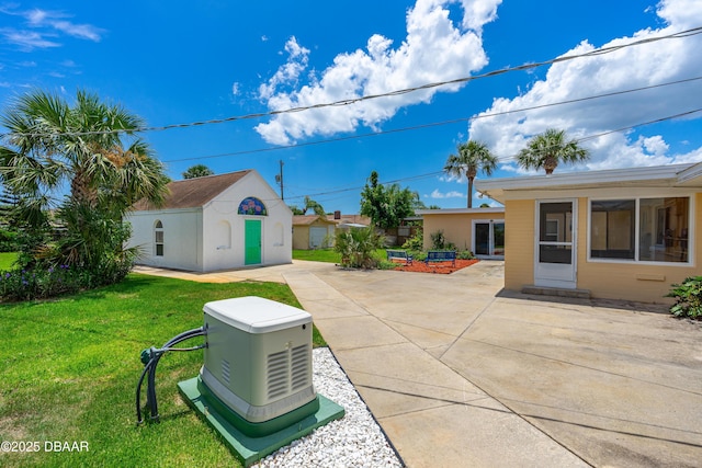 1104 Jacaranda Ave, Daytona Beach, FL 32118 - view of grassy yard featuring an outdoor structure and a patio area