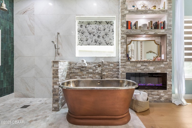 75 Trailmark Ct, Ormond Beach, FL 32174 - full bath featuring a soaking tub, a glass covered fireplace, and wood finished floors