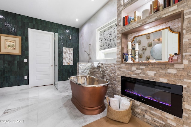 75 Trailmark Ct, Ormond Beach, FL 32174 - full bath with a freestanding bath, tile walls, a glass covered fireplace, and vanity