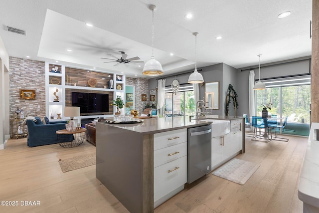75 Trailmark Ct, Ormond Beach, FL 32174 - kitchen with dishwasher, white cabinets, light wood finished floors, a large island with sink, and recessed lighting