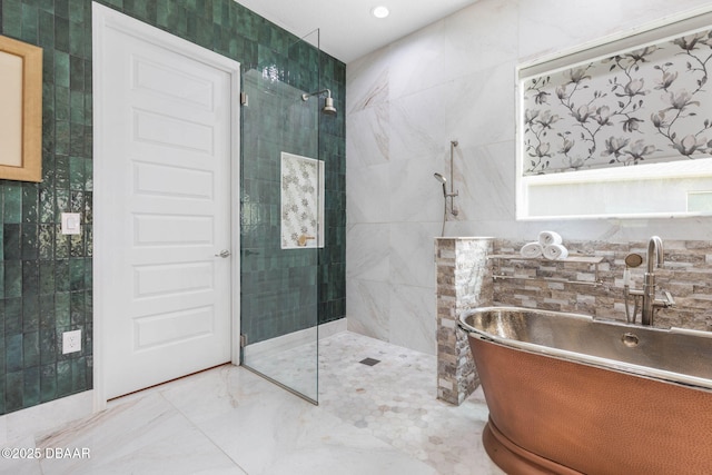 75 Trailmark Ct, Ormond Beach, FL 32174 - bathroom featuring tile walls, a freestanding tub, and walk in shower