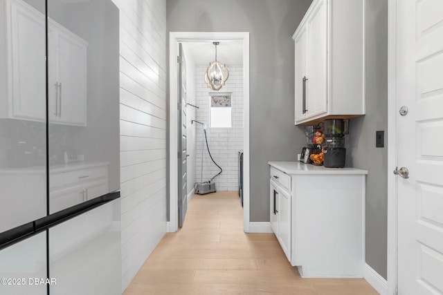 75 Trailmark Ct, Ormond Beach, FL 32174 - hall with light wood-type flooring and a chandelier