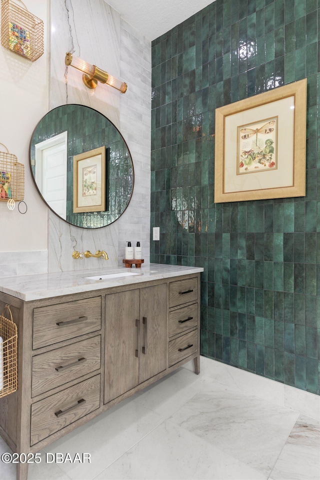 75 Trailmark Ct, Ormond Beach, FL 32174 - bathroom with tile walls, vanity, and marble finish floors