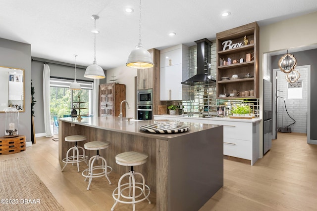 75 Trailmark Ct, Ormond Beach, FL 32174 - kitchen with wall chimney exhaust hood, appliances with stainless steel finishes, modern cabinets, open shelves, and recessed lighting