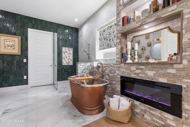 75 Trailmark Ct, Ormond Beach, FL 32174 - full bath featuring tile walls, a soaking tub, walk in shower, and a glass covered fireplace