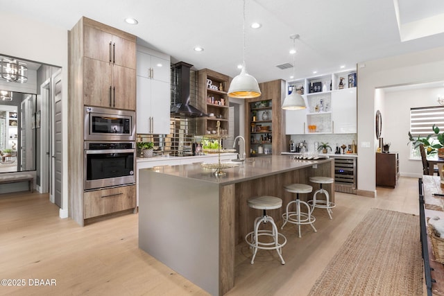 75 Trailmark Ct, Ormond Beach, FL 32174 - kitchen featuring appliances with stainless steel finishes, open shelves, beverage cooler, wall chimney exhaust hood, and backsplash