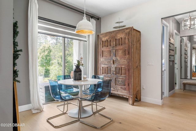 75 Trailmark Ct, Ormond Beach, FL 32174 - dining space featuring light wood-type flooring and a chandelier