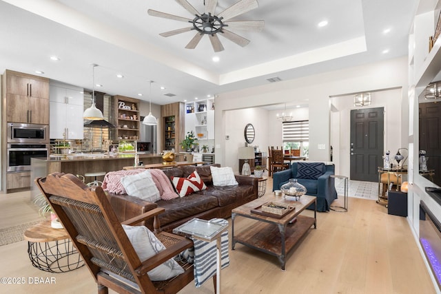 75 Trailmark Ct, Ormond Beach, FL 32174 - living area featuring light wood-style flooring, ceiling fan, recessed lighting, a chandelier, and a raised ceiling
