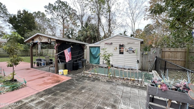 back of house with a gazebo, a storage shed, and a patio area