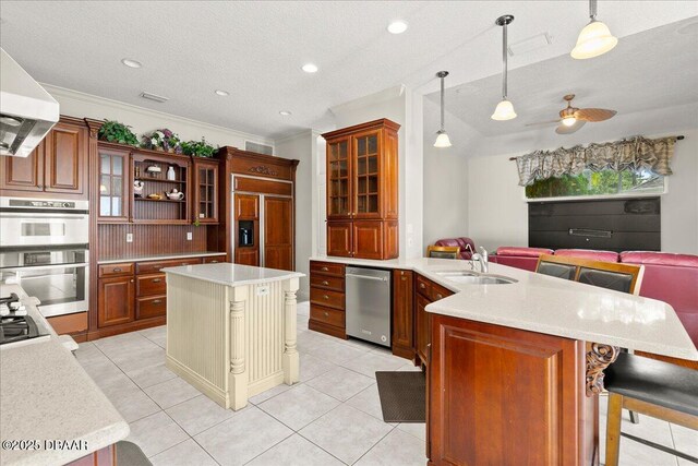 36 Allenwood Look, Ormond Beach, FL 32174 - kitchen with stainless steel appliances, open floor plan, a peninsula, range hood, and light countertops