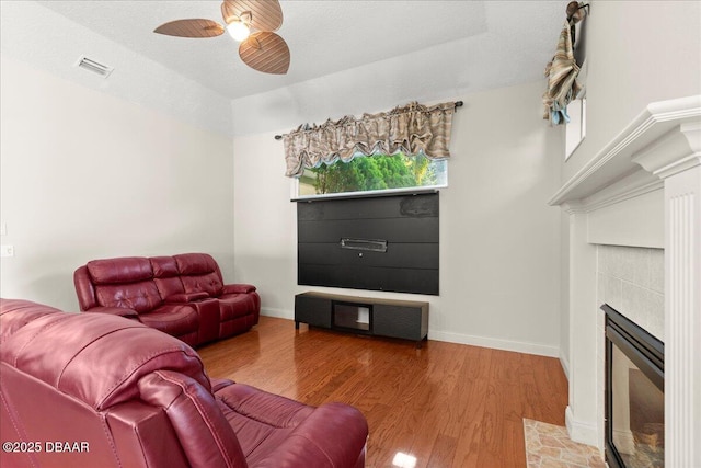 36 Allenwood Look, Ormond Beach, FL 32174 - living area featuring ceiling fan, light wood-style flooring, and a fireplace