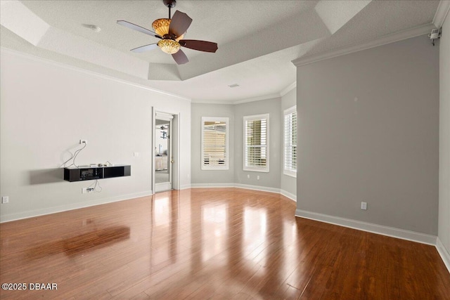 36 Allenwood Look, Ormond Beach, FL 32174 - unfurnished living room featuring crown molding, wood finished floors, a ceiling fan, and a tray ceiling