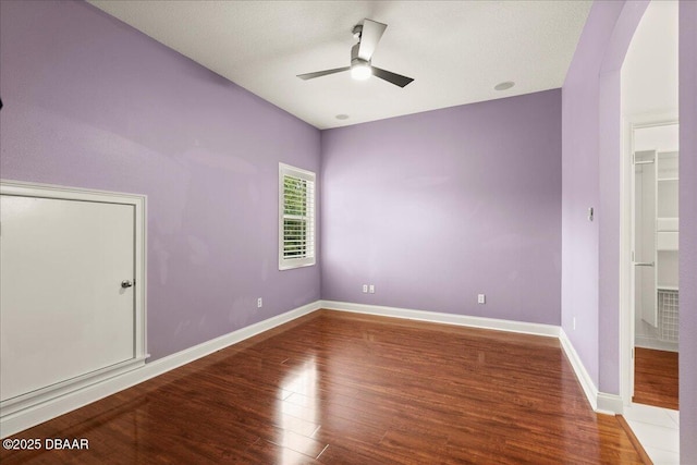 36 Allenwood Look, Ormond Beach, FL 32174 - unfurnished bedroom with arched walkways, wood finished floors, and ceiling fan