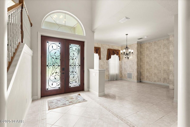 36 Allenwood Look, Ormond Beach, FL 32174 - foyer entrance with french doors, a chandelier, tile patterned floors, and crown molding