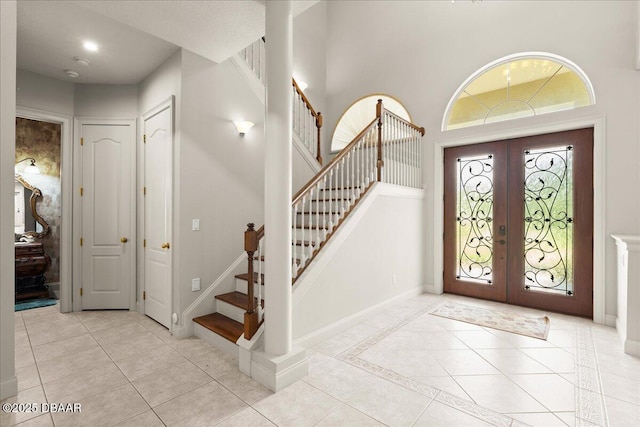 36 Allenwood Look, Ormond Beach, FL 32174 - foyer entrance featuring french doors, stairway, light tile patterned flooring, and a high ceiling