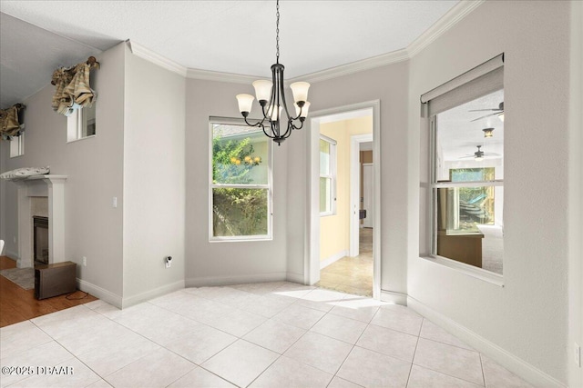 36 Allenwood Look, Ormond Beach, FL 32174 - unfurnished dining area with a fireplace with flush hearth, a chandelier, ornamental molding, light tile patterned flooring, and a ceiling fan