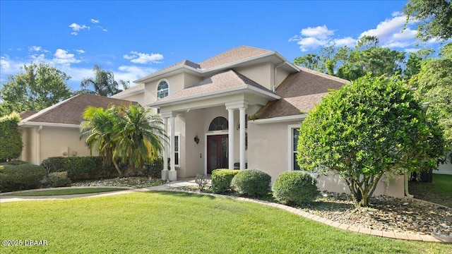 36 Allenwood Look, Ormond Beach, FL 32174 - view of front of house with stucco siding, a front lawn, and roof with shingles