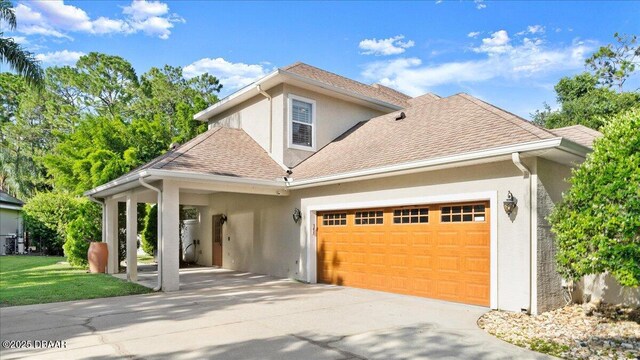 36 Allenwood Look, Ormond Beach, FL 32174 - view of front facade featuring stucco siding, concrete driveway, a garage, and roof with shingles
